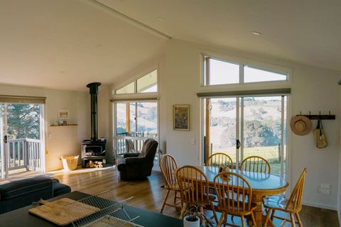 Open living and dining room with wood stove and views over the valley