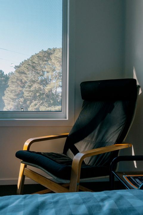 A quiet reading chair by the bedroom window