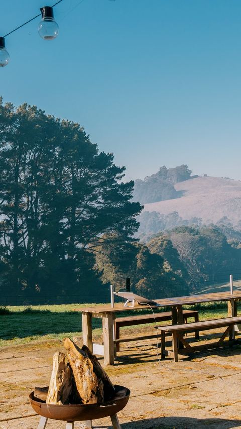 Fence line at dawn with low fog over the hills